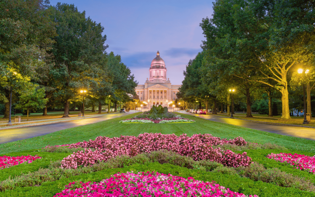 Kentucky State Capitol with flower gardens at dusk